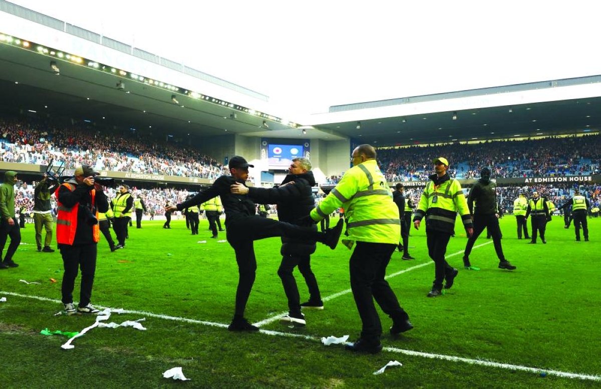 Fans in pitch battle after Celtic beat Rangers in Scottish Cup