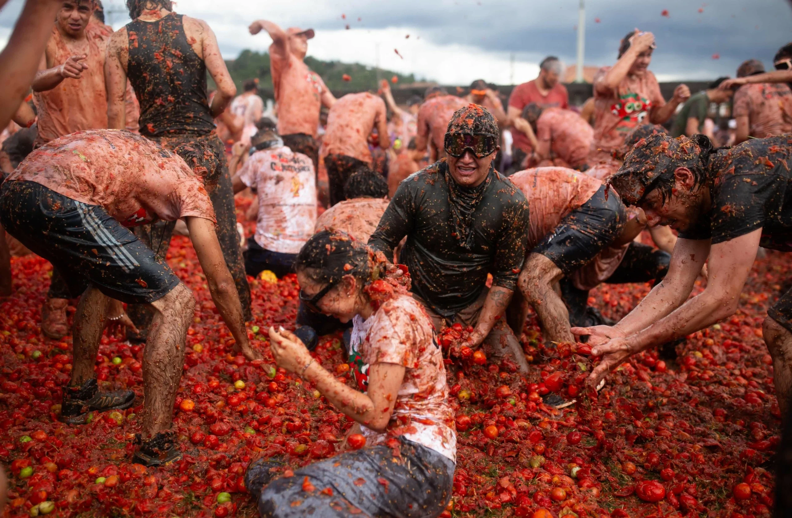 Thousands of revellers pelt each other with tomatoes at a…