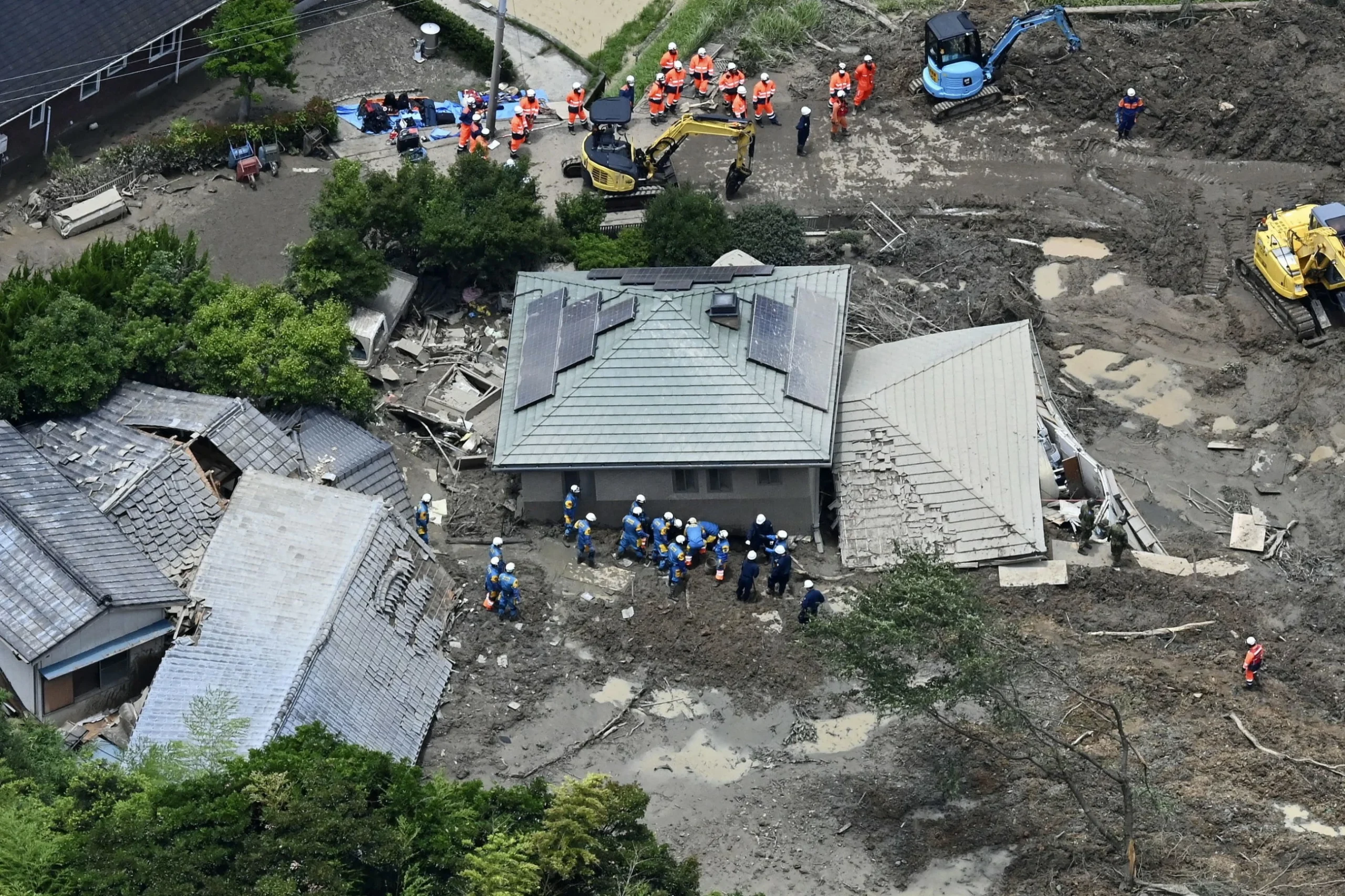 Heavy rain pounds western Japan as 2 tropical storms approach